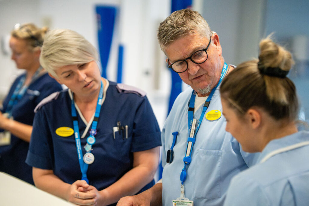 Three AMU staff having a discussion