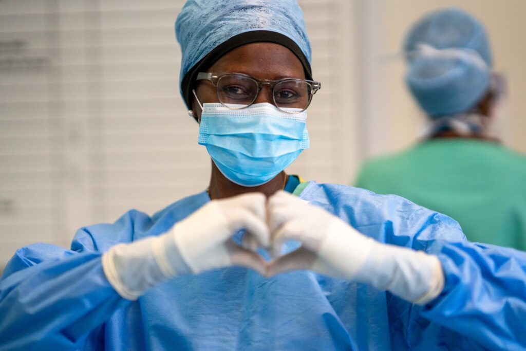 Ophthalmology surgical team member making the heart hand shape