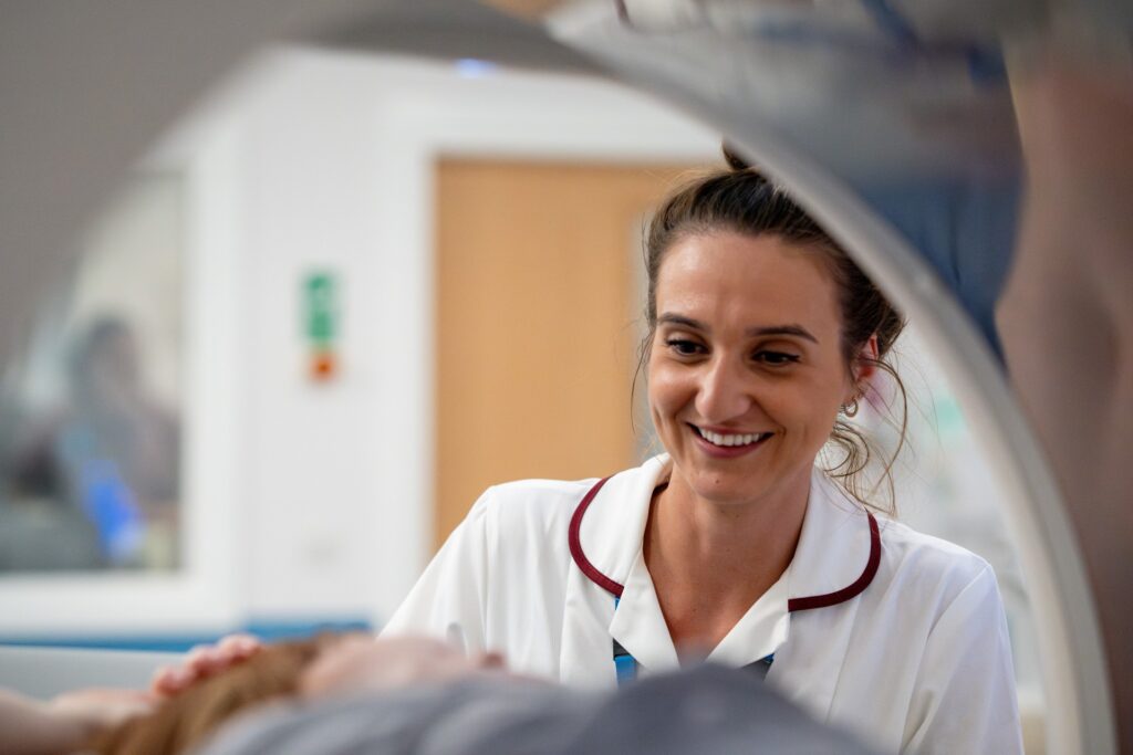 Radiographer looking after patient who is going into the MRI scanner